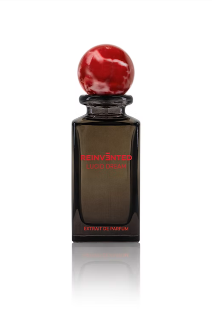 lucid dream perfume bottle by Reinvented Parfums, niche fragrance saffron rose oud, luxury unisex perfume flatlay, dreamy surreal perfume imagery