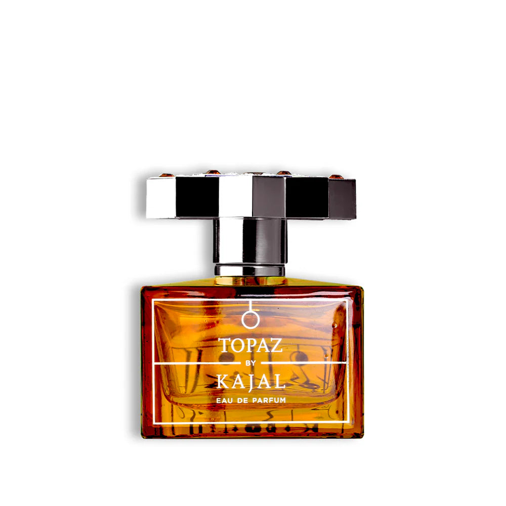 Topaz by Kajal Eau de Parfum bottle with amber glass and silver cap on a white background